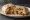 Surf and Turf Burrito: an illustration of beef, shrimp, rice, beans and more on tortilla.
