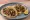 Taco: an illustration of pork, beef, onion, cilantro and more on tortilla.