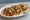 Taco al Pastor con Piña: an illustration of pork, pineapple, onion, cilantro and more on tortilla.