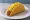Taco Bell Crunchy Taco: an illustration of beef, cheddar cheese and lettuce on tortilla.