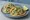 Taco de Aguachile: an illustration of shrimp, lime, cilantro, cucumber and more on tortilla.