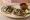 Taco de Barbacoa de Borrego: an illustration of lamb, onion, cilantro and lime on tortilla.