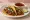 Taco de Birria: an illustration of onion, cilantro and lime on tortilla.