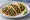 Taco de Bistec: an illustration of beef, onion, cilantro, lime and more on tortilla.