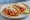 Taco de Camarón a la Diabla: an illustration of shrimp, tomato, garlic, onion and more on tortilla.