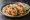Taco de Camarón Empanizado: an illustration of shrimp, cabbage, lime, mayonnaise and more on tortilla.