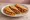 Taco de Canasta: an illustration of beans, potato, brown sauce and salsa on tortilla.