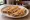 Taco de Canasta de Frijoles: an illustration of beans, onion and salsa on tortilla.