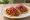 Taco de Cochinita Pibil: an illustration of pork and pickled onion on tortilla.