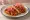 Taco de Cochinita Pibil: an illustration of pork and pickled onion on tortilla.