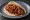 Taco de Discada: an illustration of beef, pork, bacon, chorizo and more on tortilla.