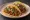 Taco de Guisado: an illustration of tomato, onion, cilantro and salsa on tortilla.