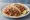 Taco de Lechón al Horno: an illustration of pork, onion, cilantro, lime and more on tortilla.