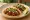 Taco de Longaniza: an illustration of onion, cilantro, lime and salsa on tortilla.