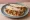 Taco de Machaca con Huevo: an illustration of egg, tomato, onion and salsa on tortilla.