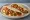 Taco de Machaca: an illustration of egg, tomato and onion on tortilla.