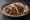 Taco de Mixiote: an illustration of lamb, onion and cilantro on tortilla.