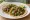 Taco de Nopales: an illustration of onion, cilantro, lime and salsa on tortilla.