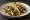 Taco de Nopales con Queso: an illustration of queso fresco, onion, cilantro and salsa on tortilla.