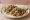 Taco de Ojo: an illustration of onion, cilantro, lime and salsa on tortilla.