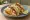 Taco de Pescado Empanizado: an illustration of fish, cabbage, sour cream, lime and more on tortilla.
