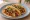Taco de Picadillo: an illustration of beef, tomato, potato, onion and more on tortilla.