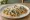 Taco de Rajas con Crema: an illustration of sour cream, onion, corn and queso fresco on tortilla.