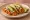 Taco de Tinga de Pollo: an illustration of chicken, tomato, onion, cilantro and more on tortilla.
