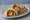 Tandoori Chicken Naan Wrap: an illustration of chicken, yogurt, onion and lemon on naan.