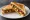 Tandoori Paneer Sandwich: an illustration of yogurt, onion and bell pepper on white bread.