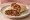 Tantuni Karışık: an illustration of beef, chicken, tomato, onion and more on pita.