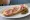 Tartine Parisienne: an illustration of ham, butter, gruyère and pickle on baguette.