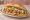 Tavuk Döner: an illustration of chicken, tomato, onion, lettuce and more on bread.