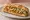 T'bit Sandwich: an illustration of chicken, rice and onion on baguette.