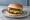 Theta Burger: an illustration of beef, american cheese, pickle, mustard and more on burger bun.