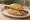 Thüringer Bratwurst: an illustration of pork, mustard and garlic on kaiser roll.