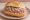 Thüringer Mett: an illustration of pork, onion and pepper on kaiser roll.