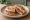 Tigelle con Prosciutto: an illustration of the sandwich.