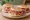Tigelle con Salumi Misti: an illustration of prosciutto, mortadella, salami and pork.