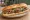 Tire Köftesi Ekmek: an illustration of beef, onion, parsley and tomato on bread.
