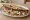 Tlayuda: an illustration of beans, cabbage, tomato, avocado and more on tortilla.