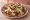 Tlayuda de Chorizo: an illustration of chorizo, pork, beans, cabbage and more on tortilla.