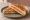 Toast al Salmone: an illustration of salmon, cheese and butter on white bread.