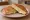 Toast Quattro Formaggi: an illustration of mozzarella, fontina, parmesan and butter on white bread.