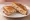 Toast with Tuna (טוסט עם טונה): an illustration of tuna, mayonnaise, cheese and butter on white bread.