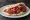 Tomatokeftedes se Pita (Ντοματοκεφτέδες): an illustration of tomato, onion, mint and tzatziki on pita.