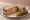 Tongue Sandwich: an illustration of mustard and pickle on rye bread.
