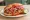 Torta Ahogada Media: an illustration of pork and pickled onion.