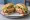 Torta Cubana: an illustration of katsu, ham, hot dog, egg and more on bread.