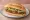 Torta de Chicharrón Prensado: an illustration of refried beans, avocado, onion and cilantro on bread.